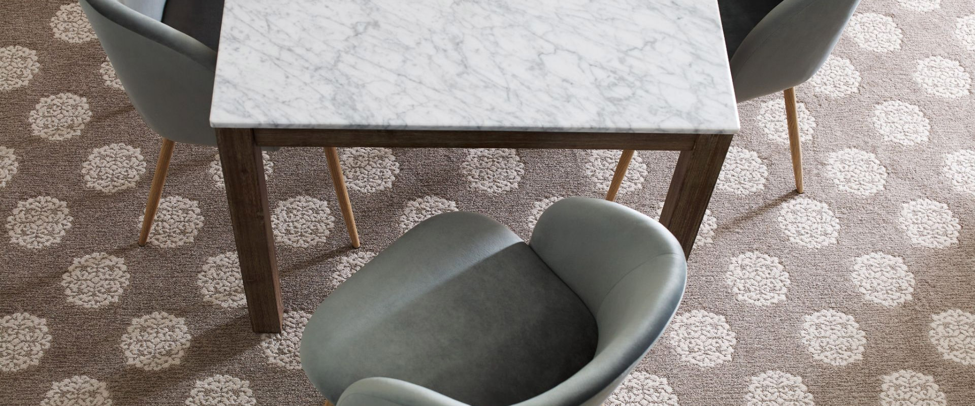 Photo of stylish chairs and table on Anderson Tuftex rug